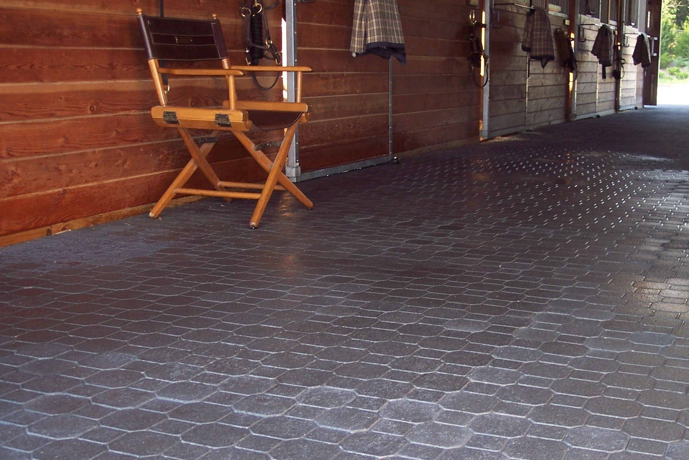 Rubber interlock flooring inside horse barn, ideal flooring solution for horses