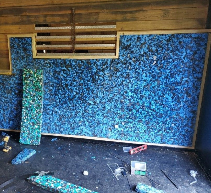 Padded wall being installed, showing the underpad, an ideal solution for a comfortable horse stall